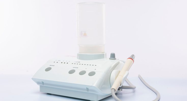 Microsuction ear wax removal machine on a plain background
